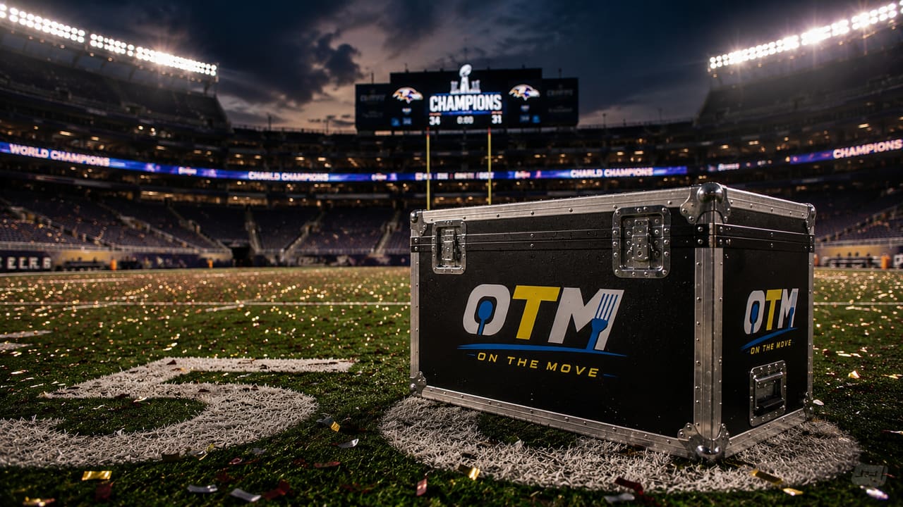 An OTM case sits on the championship field under the CHAMPIONS scoreboard as confetti settles